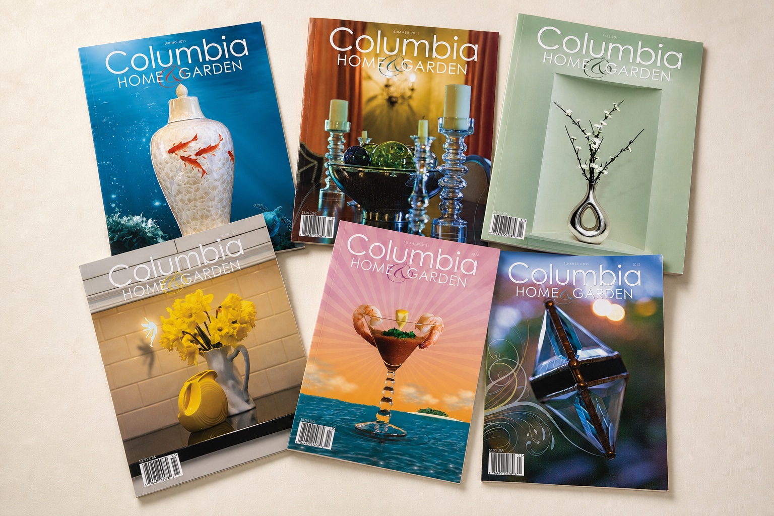 Six Columbia Home & Garden magazine covers scattered across an editorial work surface